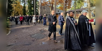 Die Geistlichen ziehen zum Friedhofskreuz, die Gläubigen folgen. (Bild: R. Kreuzer)