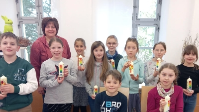 Sabine Stier freut sich mit den Kindern über die selbst gebastelten Osterkerzen. (Bild: Stadt Tirschenreuth/exb)