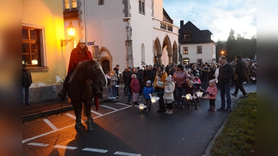 Der Heilige St. Martin hoch auf dem Pferd führt den Laternenzug der Kinder nach der Martinsfeier in der Stadtpfarrkirche an.  (Bild: bey)