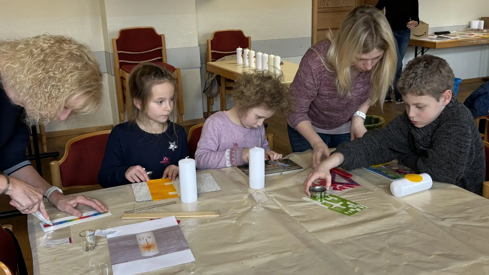 Noch einen Silberfaden hier und ein Glitzersteinchen dort und die bunt geschmückten Osterkerzen der Kinder sind fertig. Mit Unterstützung von Mama und Oma geht es doch ein bisschen leichter, die Osterkerzen zu basteln.  (Bild: cro)