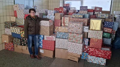 Bild zeigt Elke Kirchberger in der zentralen Paketsammelstelle in Pressath, mit bereits auch von anderen Sammelstellen angelieferten Weihnachtspäckchen zum Weitertransport in die Region (Bild: Erwin Kirchberger)