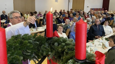 Zu Beginn des besinnlichen Nachmittags für die Senioren Nabburgs im Jugendwerk zündet Pfarrer Hannes Lorenz die erste Kerze am Adventskranz an.  (Bild: aub)