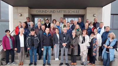 Im Eingang der Grund- und Mittelschule kamen die ehemaligen Schülerinnen und Schüler des Jahrgangs 1963/64 zum Erinnerungsfoto an das Klassentreffen zusammen.  (Bild: Anni Reiter )