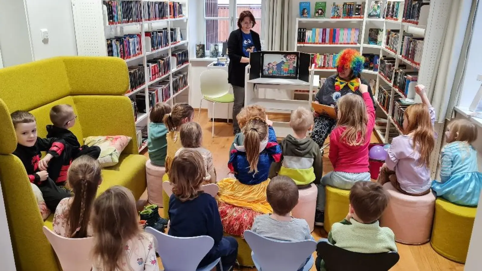 Bibliotheksmitarbeiterin Sonja Schecklmann assistiert Vorleserin Karin Reul beim Kamishibai Erzähltheater  (Bild: Petra Danzer)