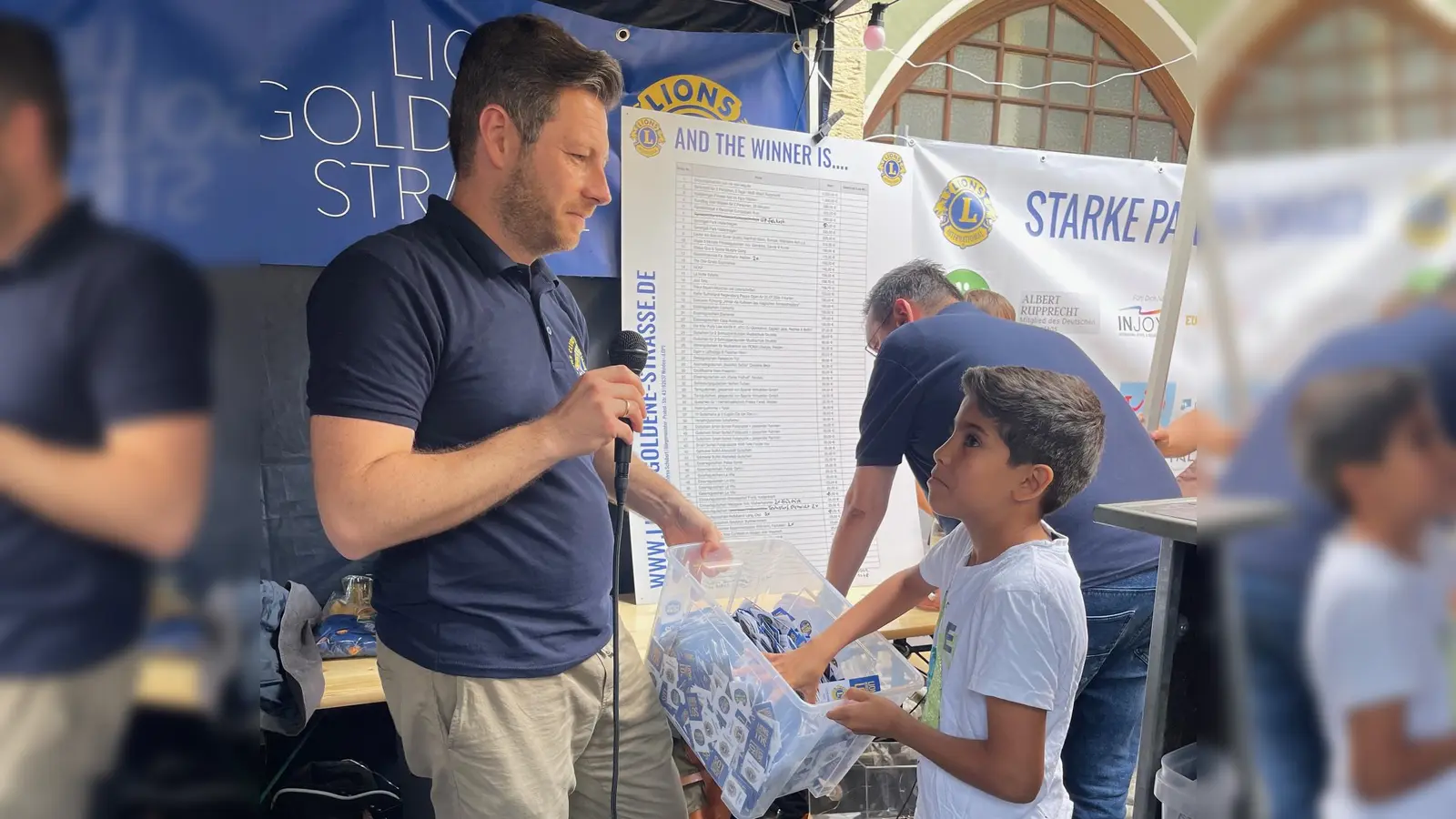 Der künftige Lions-Präsident Christoph Skutella mit Hassan Al Souadi, der die Gewinnlose zieht. (Bild: Petra Schober/exb)