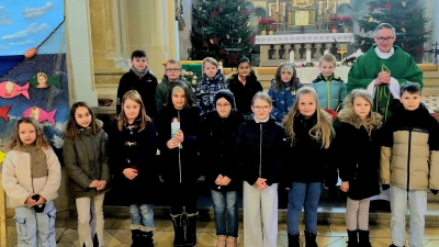 Die 15 Erstkommunionkinder mit Pfarrer Adam Karolczak beim Vorstellungsgottesdienst. (Bild: Erika Parton)