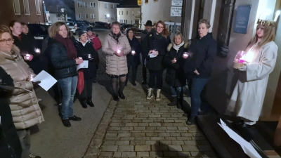 Besucher mit Licht bei der Eröffnung des Adventsfensters. (Bild: Georg Dürr)