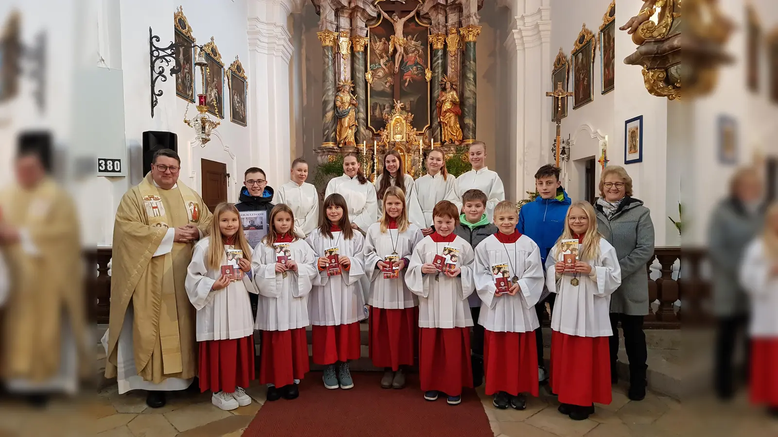 Strahlende Gesichter gab es bei der Neuaufnahme von sieben Ministrantinnen und Ministranten in der Wieskirche. Pfarrer Udo Klösel (links) und Pfarrgemeinde-Sprecherin Elisabeth Völkl (rechts) gratulierten.<br><br> (Bild: gi)